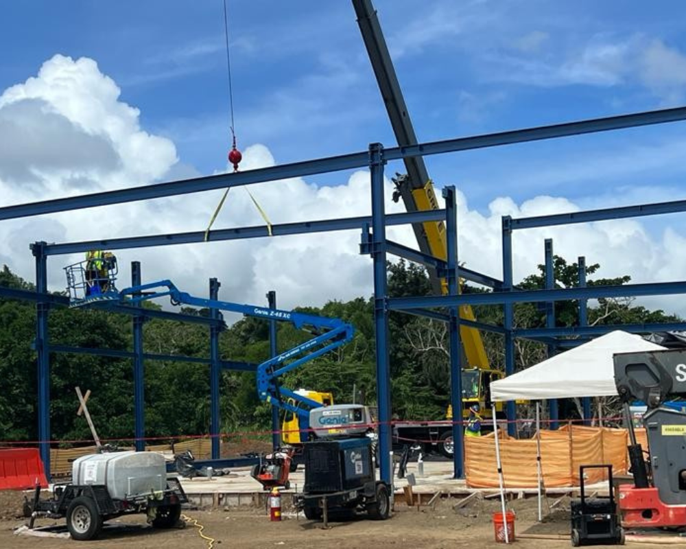 Industrial construction site with heavy equipment and workers